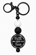 Faith Over Fear beaded keychain in black and white with matte black hardware and black circular Faith Over Fear charm