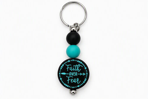 Faith Over Fear keychain with black and turquoise beads, a round black charm with turquoise lettering, and a silver-tone key ring.