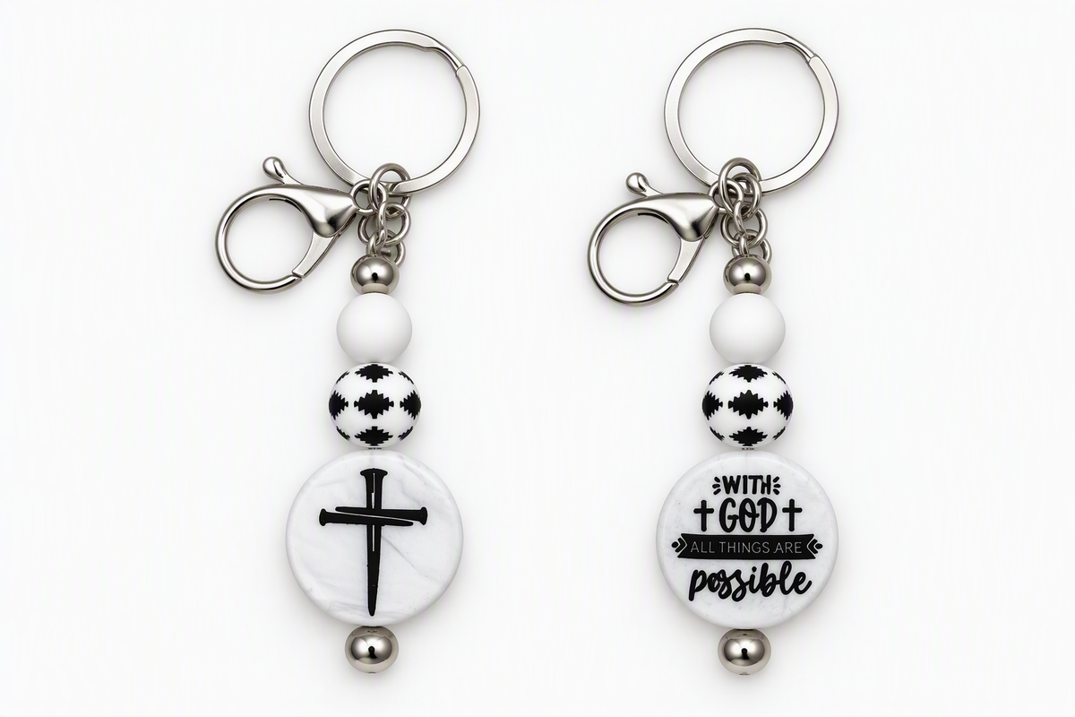 Black-and-white beaded keychains showcasing a cross design and the message With God All Things Are Possible, with silver-tone key rings and lobster clasps.