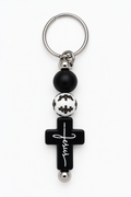 Black cross keychain with Jesus in white script, black and white beads, and a silver-tone key ring.