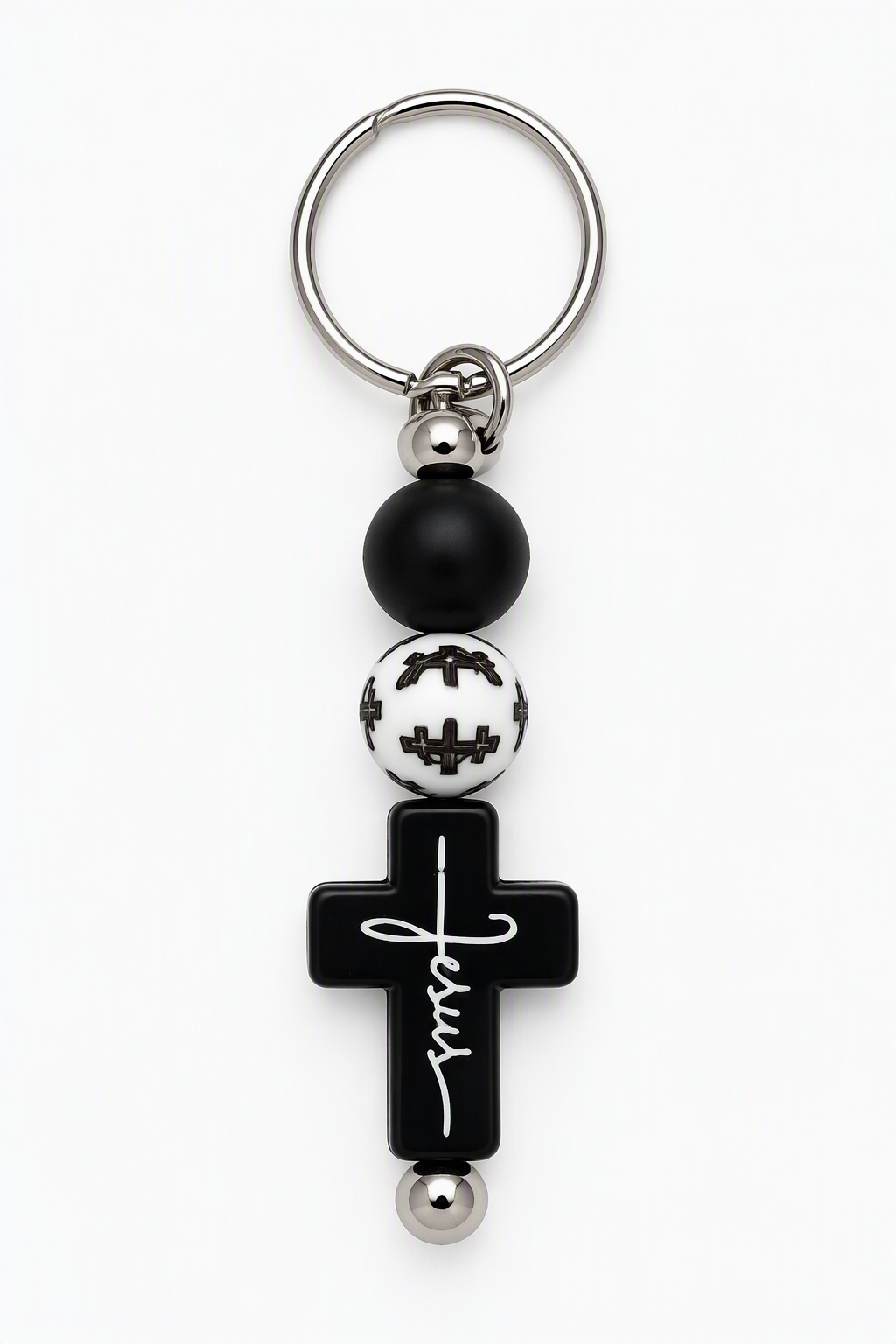 Black cross keychain with Jesus in white script, black and white beads, and a silver-tone key ring.
