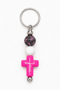 Hot pink cross keychain with Jesus in white script, white and patterned beads with pink details, and a silver-tone key ring.